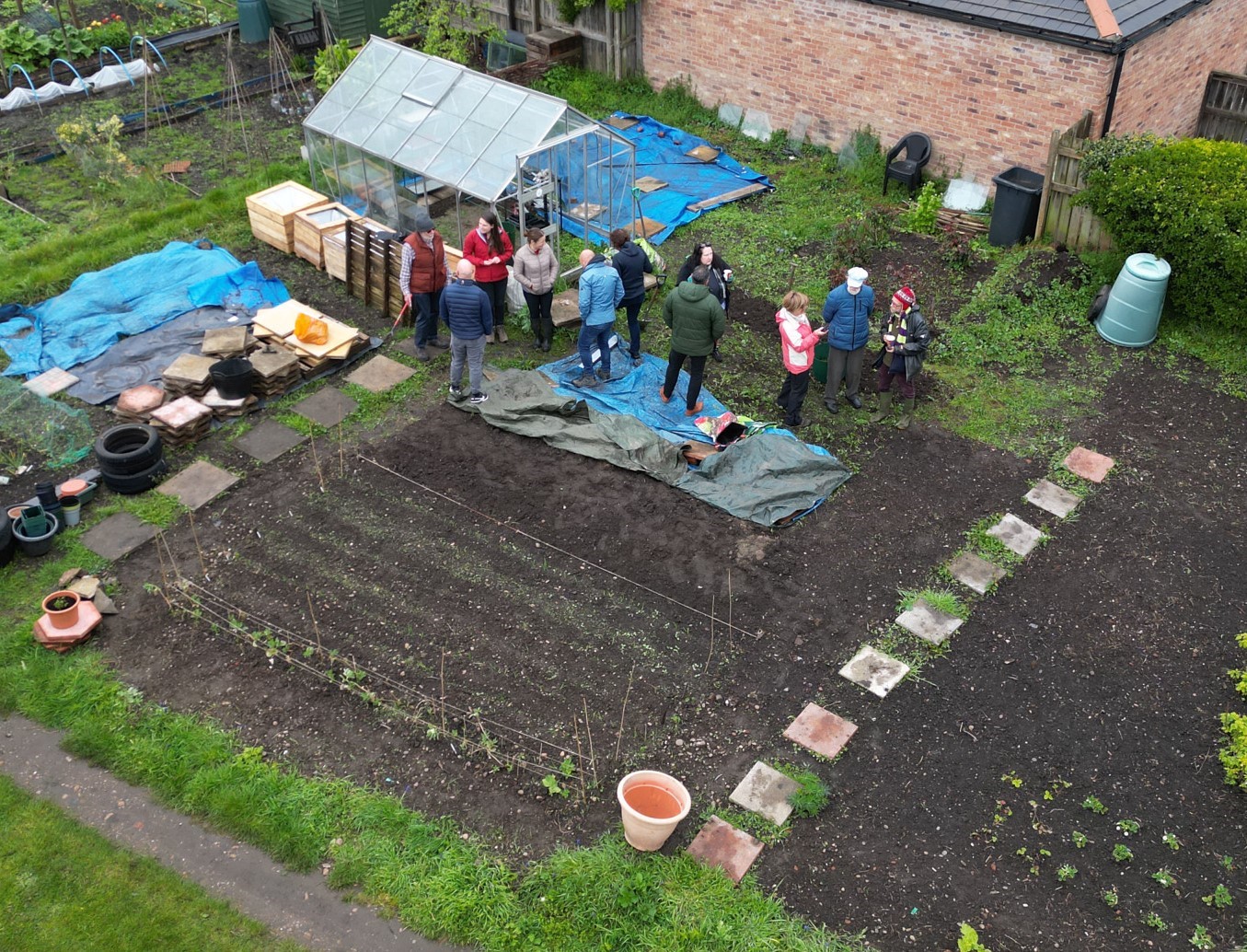 Group of volunteers stand together at allotment plot in Bawtry 